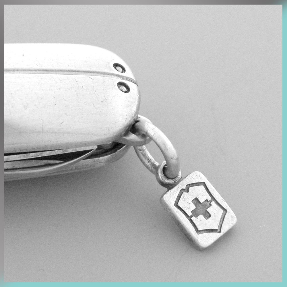 Victorinox Swiss Pocket Knife blade logo charm Tiffany & and Co. Streamerica Sterling Silver Collection 2002 .925 Detail of Swiss Flag simbol