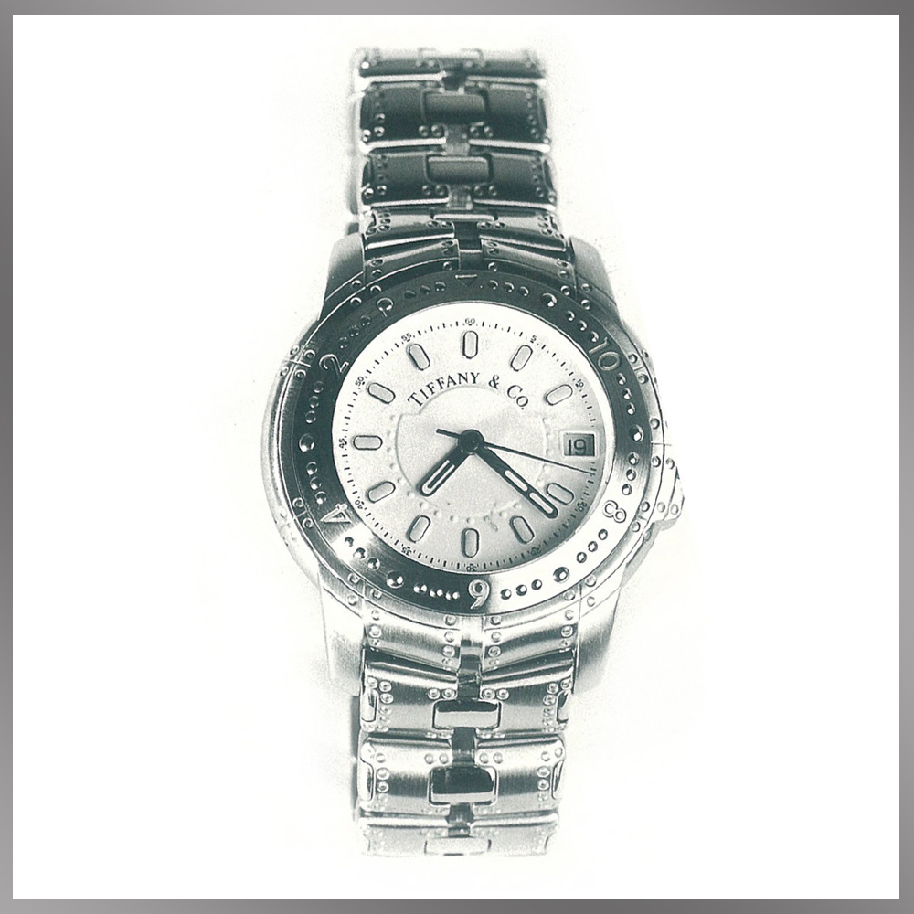 Tiffany & Co. Streamerica Automatic Chronometer Watch with white face and dial. Stainless Steel band with double deployable buckle. From the 1993 Streamerica Catalog.